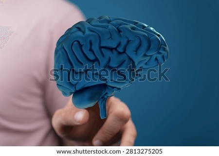 Human brain held in hand, concept of thought, intellect, innovation