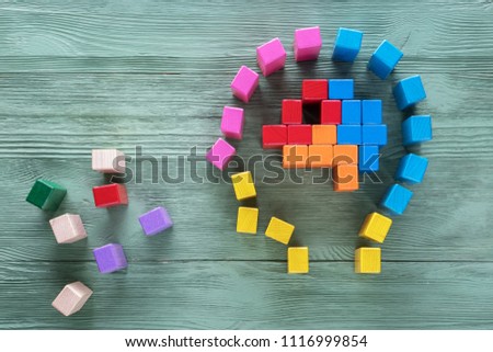 Human brain is made of multi-colored wooden blocks. Creative medical or business concept. Logical tasks. Conundrum, find the missing piece of the proposed.