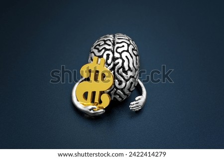 Human brain model delicately clasping a golden dollar sign in its hand. Intellect and wealth accumulation related concept.