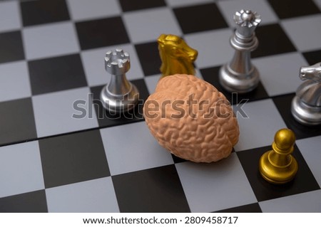 Human Brain Model on Chessboard Surrounded by Chess Pieces for Strategic Thinking Concept