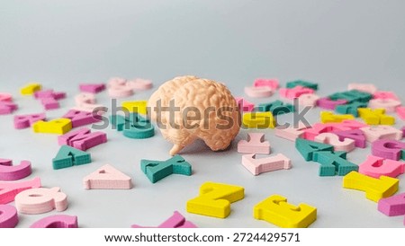 Human Brain Model Surrounded by Colorful Alphabet Letters Symbolizing Education, Learning, Cognitive Development, and Knowledge Concept. 