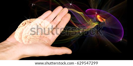 The human brain on an open palm on a black background. Hypnosis mysteries. The subconscious mind