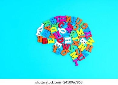 Human brain shape made from colorful wooden letters, arranged on a light blue background. Vibrant learning and education related concept. - Powered by Shutterstock