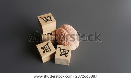 A human brain and wooden blocks with shopping carts icon. Consumer behavior, impulse buying and shopping addiction concept. 