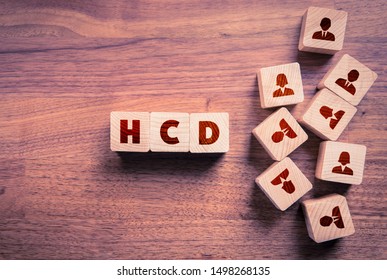 Human Centered Design (HCD) Concept. Wooden Cubes With Text HCD And Cubes With People Icons Representing Word Human.