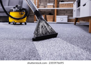 Human Cleaning Carpet In The Living Room Using Vacuum Cleaner At Home