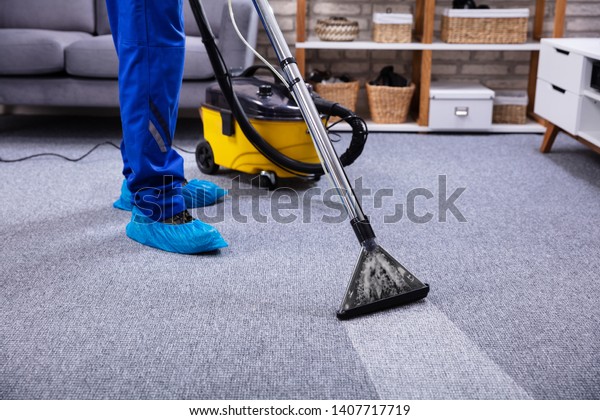 Human Cleaning Carpet In The Living Room Using\
Vacuum Cleaner At Home