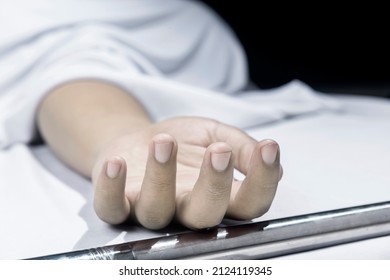 Human corpse covered with a sheet in the morgue - Shutterstock ID 2124119345