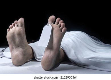 Human Corpse Covered With A Sheet And Name Tag On Toe In The Morgue