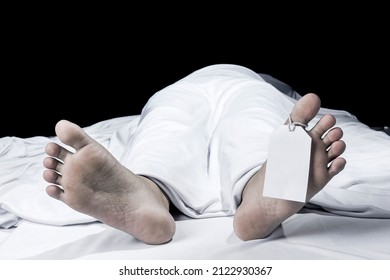 Human Corpse Covered With A Sheet And Name Tag On Toe In The Morgue