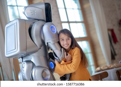 Human Dn Robot. Cute Girl Feeling Good With Her Robot Friend Hugging Him