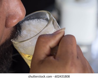 HuMan drinking beer.Focus beermug