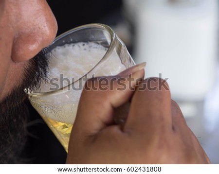 HuMan drinking beer.Focus beermug
