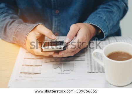 Human drinking coffee He's using Mobile phone (vintage tone)