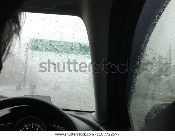 Human driving car at rainy
day.