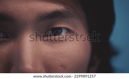 Human eyes of the Asian race. Young beautiful male opens eastern eyes. Extreme close up of an asian man's eyes opening and looking at camera. The awakening of civilization. Ethnicity. Close-up.