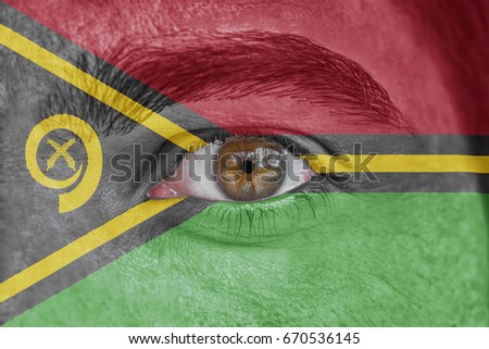 Human face and eye painted with flag of Vanuatu