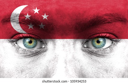 Human Face Painted With Flag Of Singapore