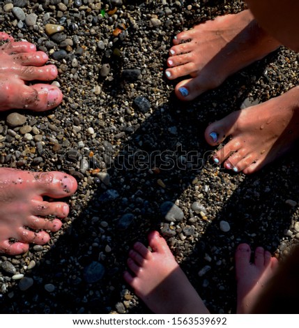 Human feet on pebbles resting, direct sunlight