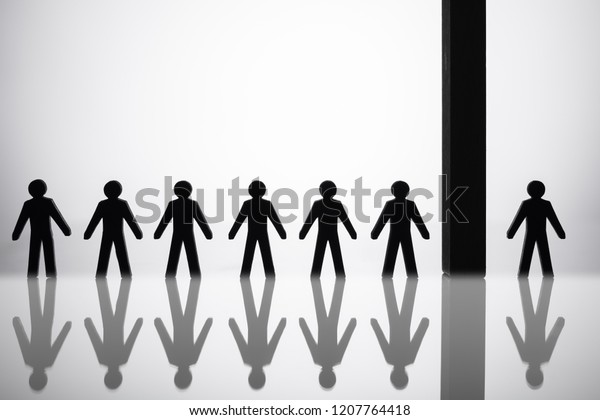 Human Figure Separated By Block From Others Standing\
In A Row