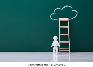 Human Figure Standing Near Ladder Leaning On Chalkboard With Cloud - Powered by Shutterstock