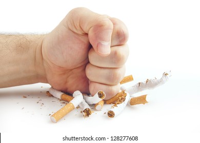Human fist breaking cigarettes Anti smoking concept