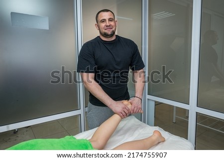 Human foot massage in a spa salon.Hands of doctor masseur making manual massage of feet for lying woman in wellness clinic. Professional chiropractor during work concept