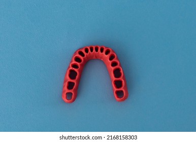 Human Gums Without Teeth Model Medical Implant Isolated On Blue Background. Healthy Teeth, Dental Care And Orthodontic Concept.