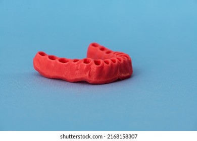 Human Gums Without Teeth Model Medical Implant Isolated On Blue Background. Healthy Teeth, Dental Care And Orthodontic Concept.