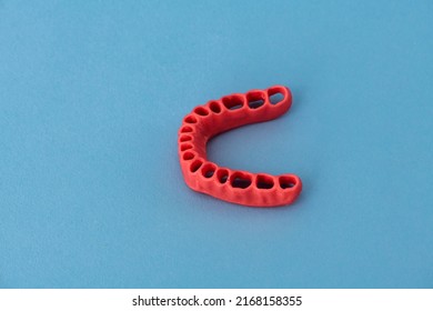 Human Gums Without Teeth Model Medical Implant Isolated On Blue Background. Healthy Teeth, Dental Care And Orthodontic Concept.