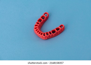 Human Gums Without Teeth Model Medical Implant Isolated On Blue Background. Healthy Teeth, Dental Care And Orthodontic Concept.