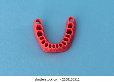 Human Gums Without Teeth Model Medical Implant Isolated On Blue Background. Healthy Teeth, Dental Care And Orthodontic Concept.