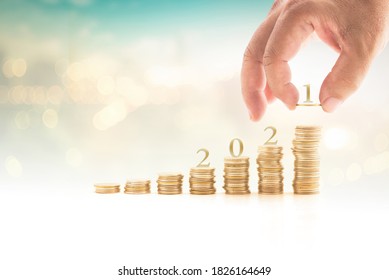 Human hand arrange 2021 letter on stack of coin - Shutterstock ID 1826164649