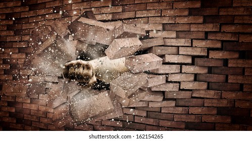 Human Hand Breaking Brick Wall. Strength And Power