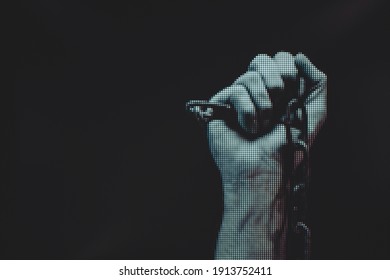 Human hand are chained in chains isolated on black background. Macro  photography view. Close-up of pixel.