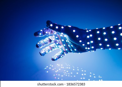 human hand covered with blue led lights, illuminated background