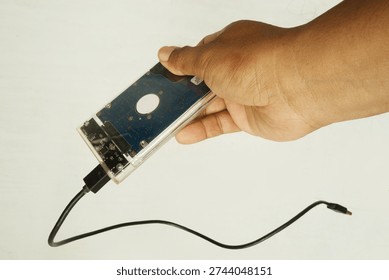 Close‑Up of Human Hand Displaying Computer Harddisk