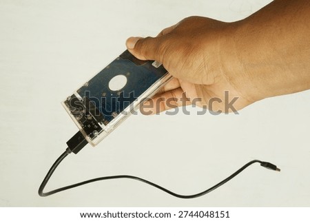 Close‑Up of Human Hand Displaying Computer Harddisk