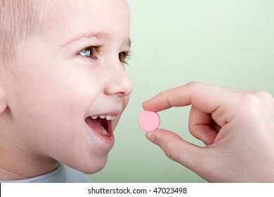 Human Hand Giving Child Medicine Healthcare Pill