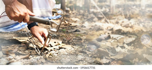 Human hand hammering the tent peg to the ground at the campsite, with copy space for text on the beside. Focus on a tent peg. - Powered by Shutterstock