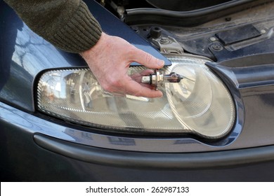 Human Hand Holding Broken H4 Car Light Bulb, Mechanic Servicing Light 