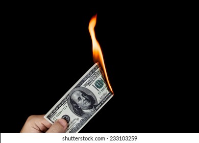 Human Hand Holding A Burning 100 Dollar Bill