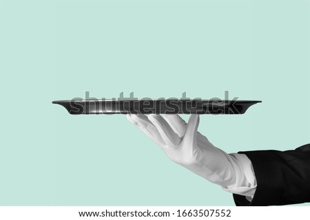 Human hand holding an empty tray