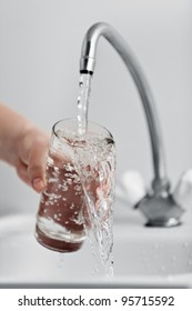 Human Hand Holding Glass Pouring Fresh Drink Water At Kitchen Faucet