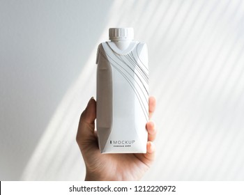 Human hand holding paper bottle mockup