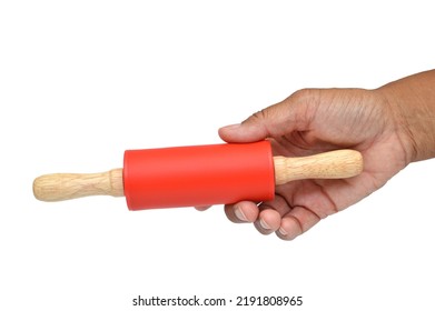 Human Hand Holding Red Wood Rolling Pin On White Background