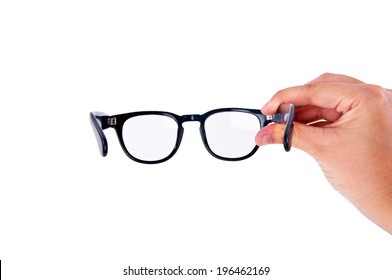 Human Hand Holding, Wearing Clear Eyeglasses Glasses with Black Frame Fashion Vintage Style Isolated on white background.