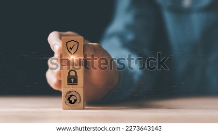 Human hand holding a wooden block , cyber security protection ,Protecting data from theft ,secure login authorization,cyber security ,digital security unlocking or encryption, virus protection 

