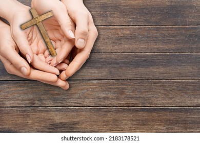 Human Hand Holding Wooden Cross Crucifix. Catholicism, Christianity, Thanksgiving, Catholic And Christian Faith Concept.