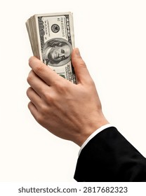 A human hand holds a substantial stack of American currency symbolizing prosperity and economic power
